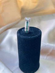 Graceful Duo: Round Diamond Solitaire with Green Accent Stone