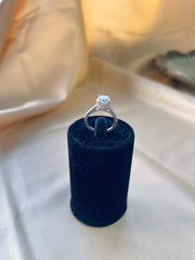 The Aurora Ring: A Solitaire Diamond Framed by Radiant Side Gems