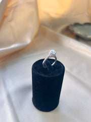 The Aurora Ring: A Solitaire Diamond Framed by Radiant Side Gems